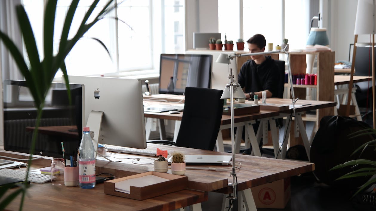 Free Man Sitting in Front of Computer Stock Photo