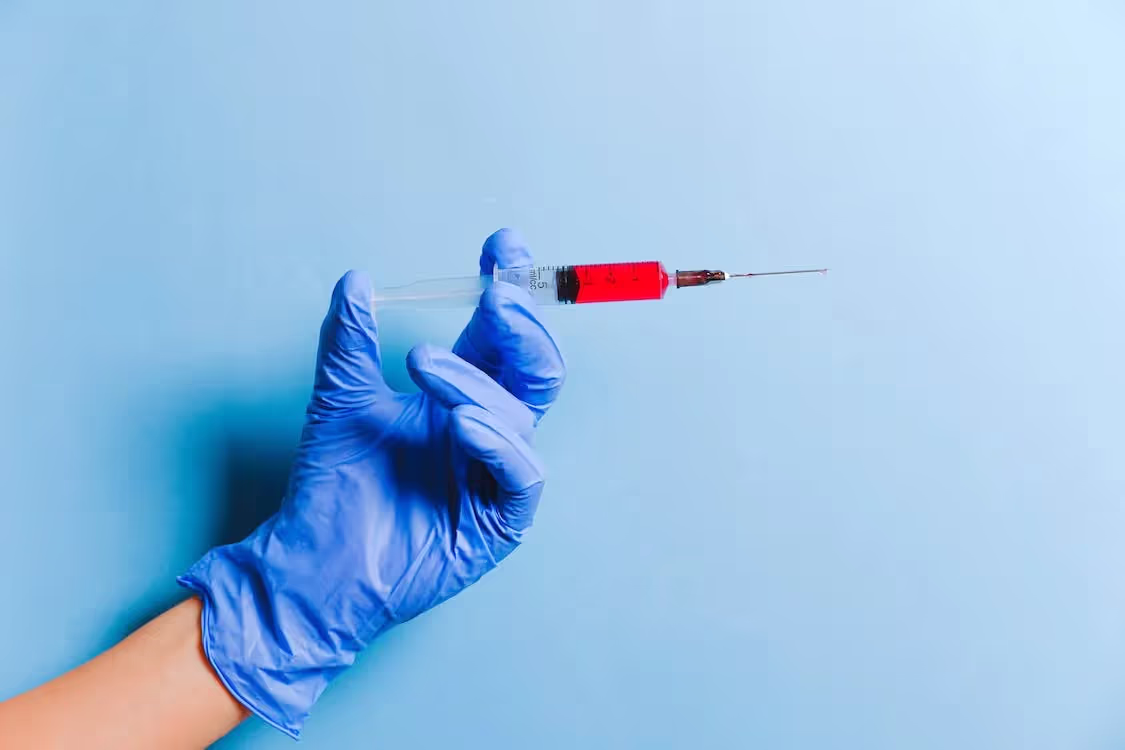 Free Person Holding Syringe Stock Photo