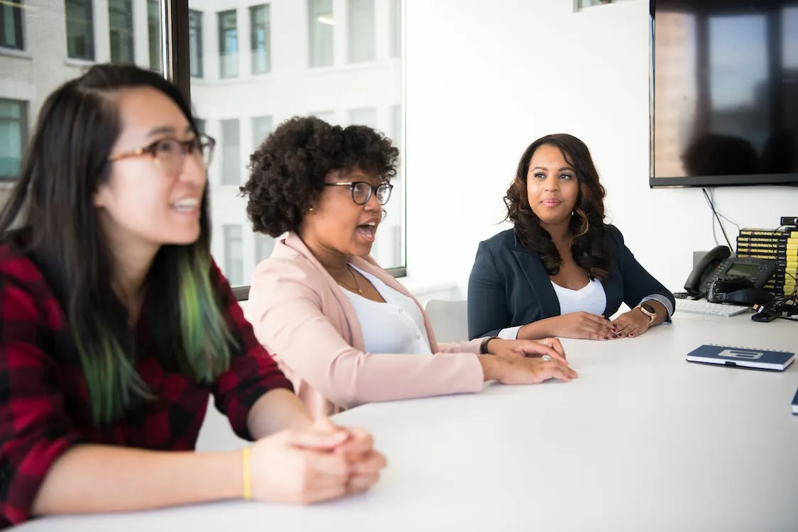 Free Three Women Sitting Beside White Table Stock Photo