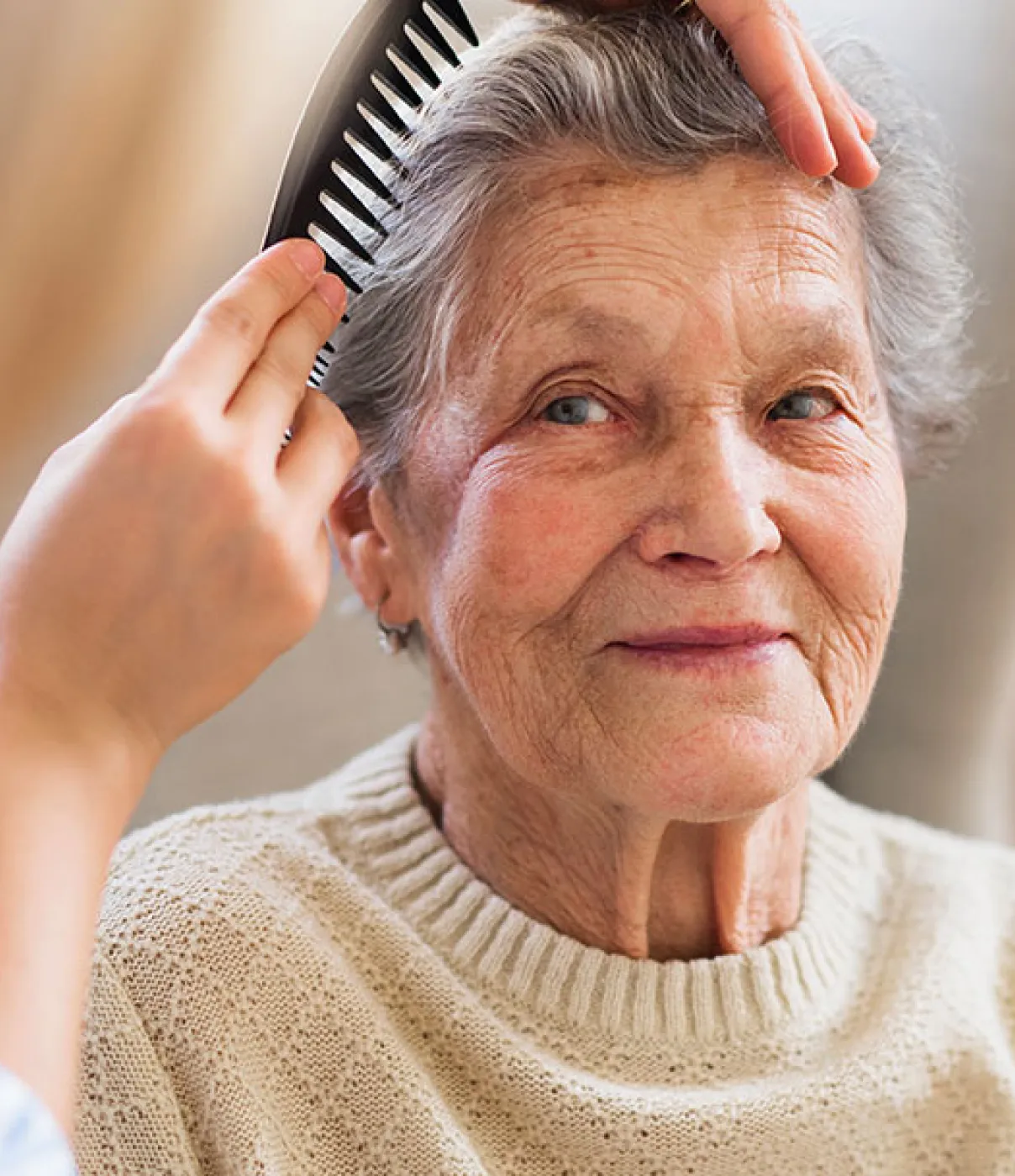a senior woman getting her hair brush