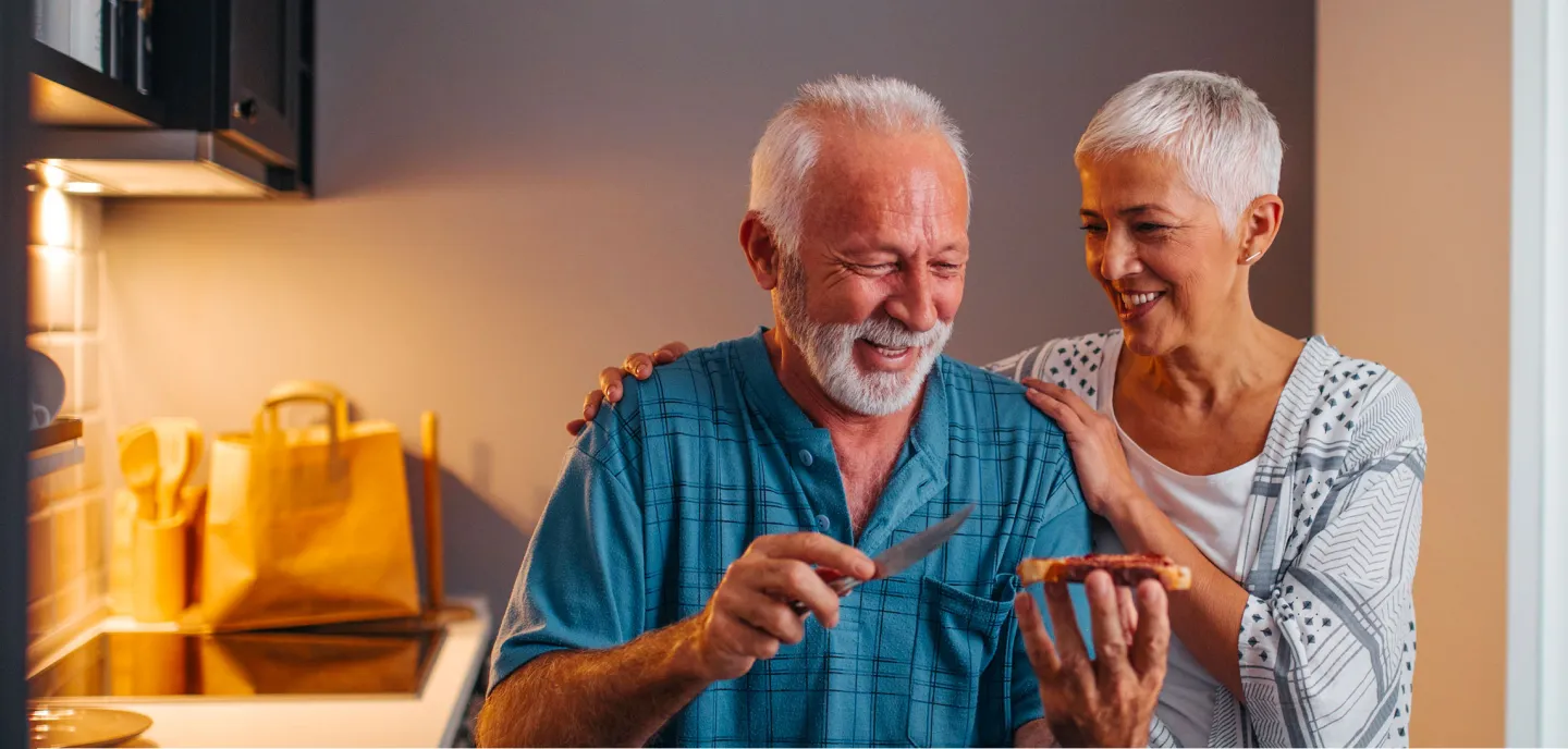 Image 6: Older couple smiling on the kitchen
