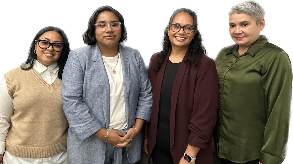 Image 2: A diverse group of individuals smiling and posing together for a photograph in a cheerful setting.