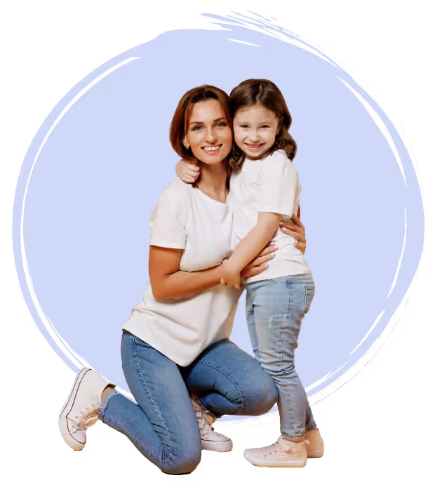 A mother hugging her little girl, both of them smiling happily.