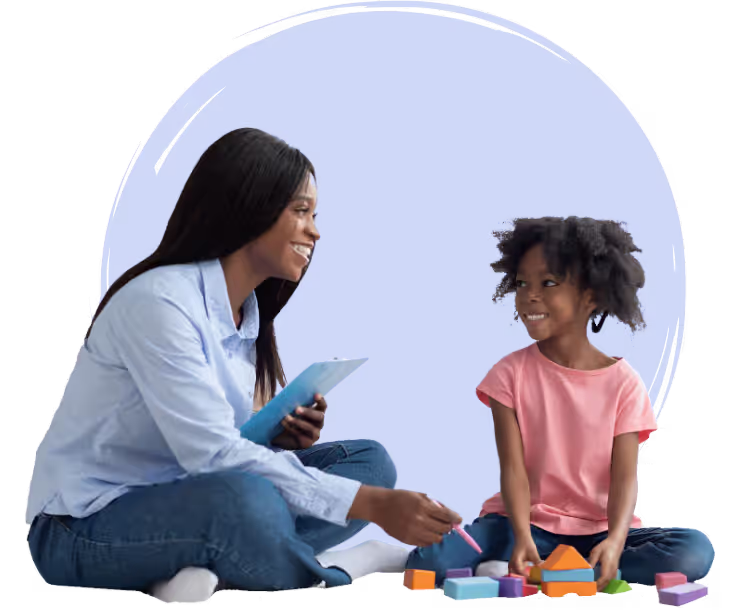 a woman sitting on the floor with a child