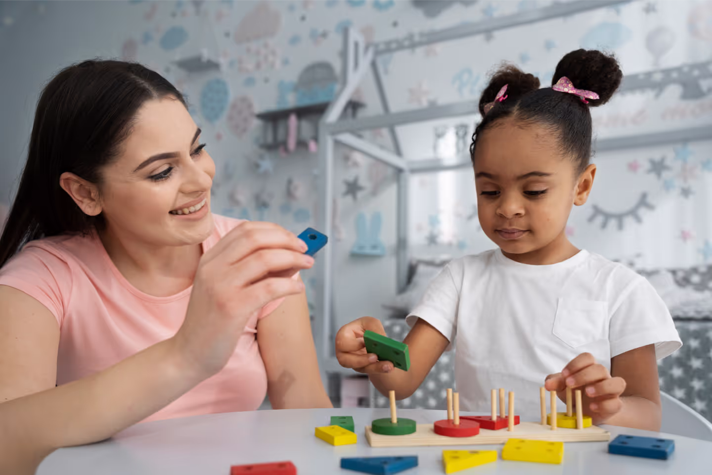 a woman and a child playing with wooden blocks