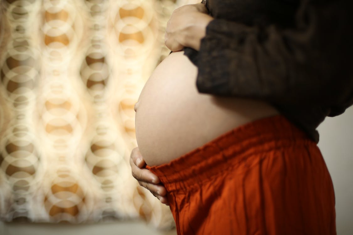 Free Pregnant Woman in Black Long Sleeve Shirt and Red Pajamas Stock Photo