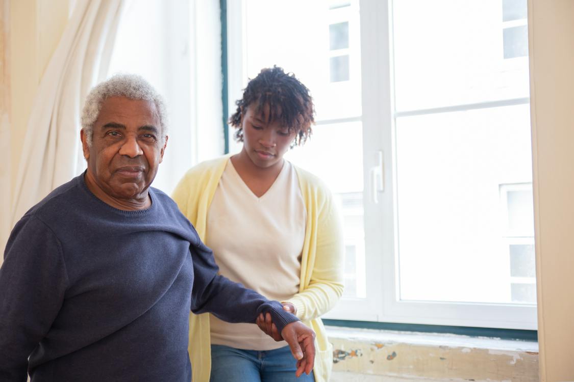 Free A Woman in Yellow Cardigan Holding the Man's Arm Stock Photo
