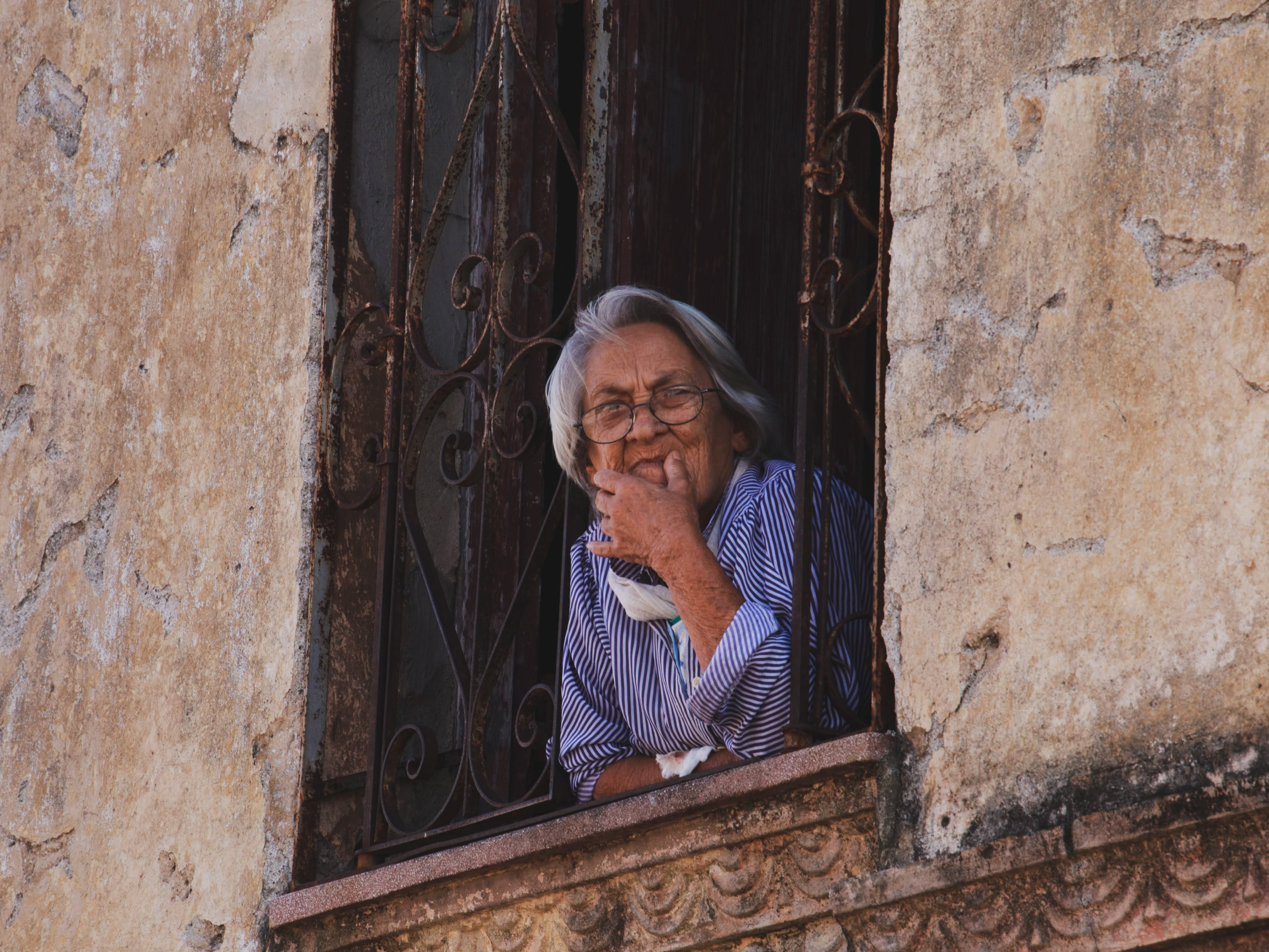 Free An Elderly Woman on a Window Stock Photo