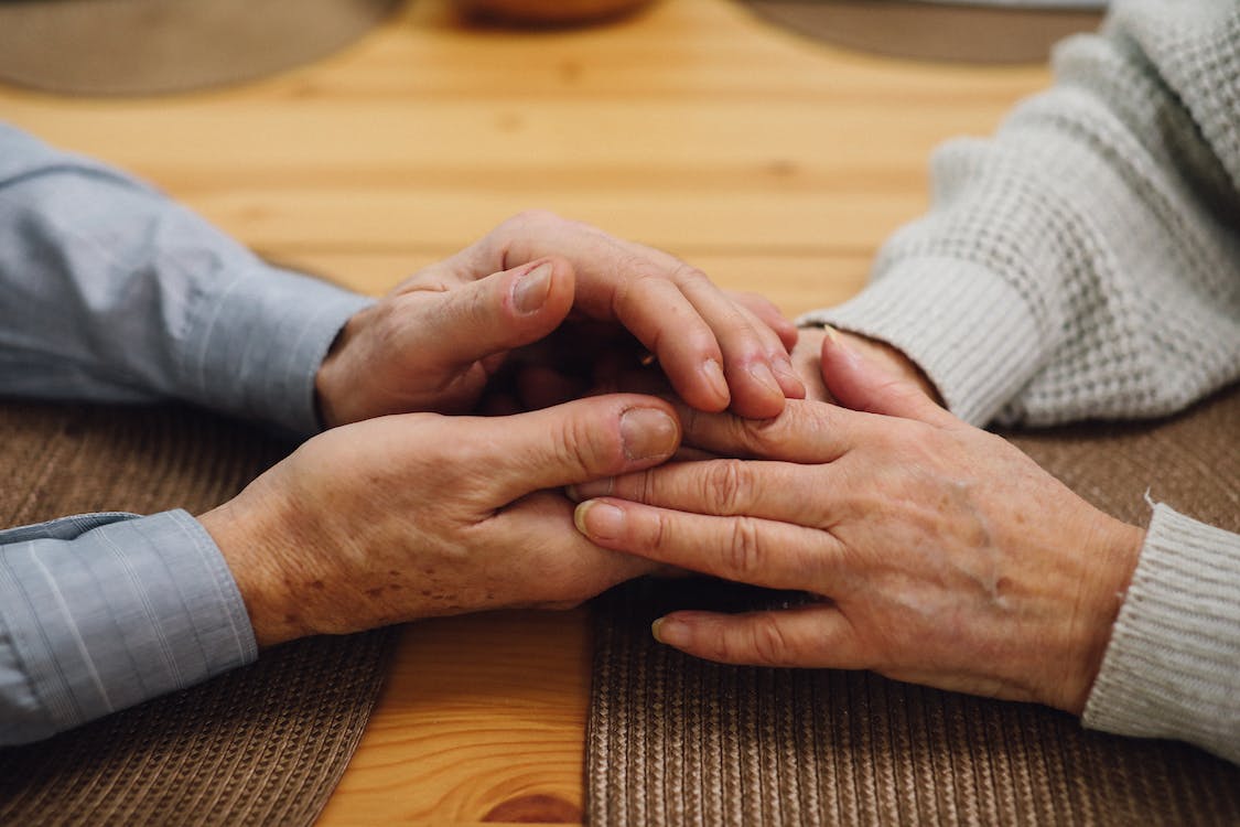 Free Close-up Photo of an Elderly Couple Holding Hands Stock Photo
