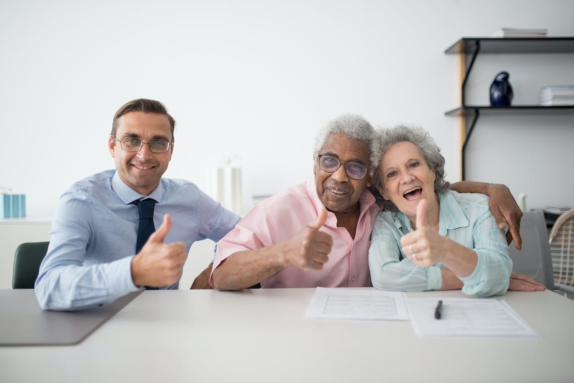 Free Man in Blue Long Sleeve Shirt and Blue Necktie Sitting beside Man in Pink Button Up Shirt Stock Photo