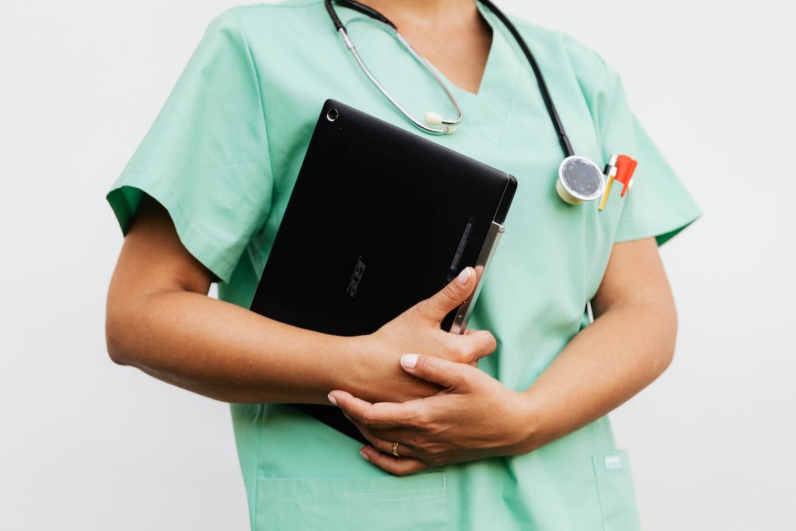 Free A Doctor Holding a Digital Tablet Stock Photo
